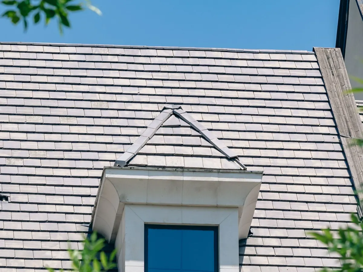 Asphalt shingle roof on a residential home, with a gable dormer